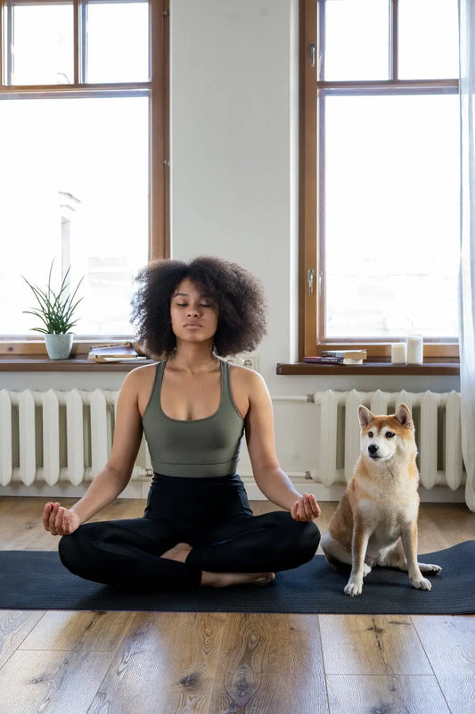 Lady doing yoga with dog